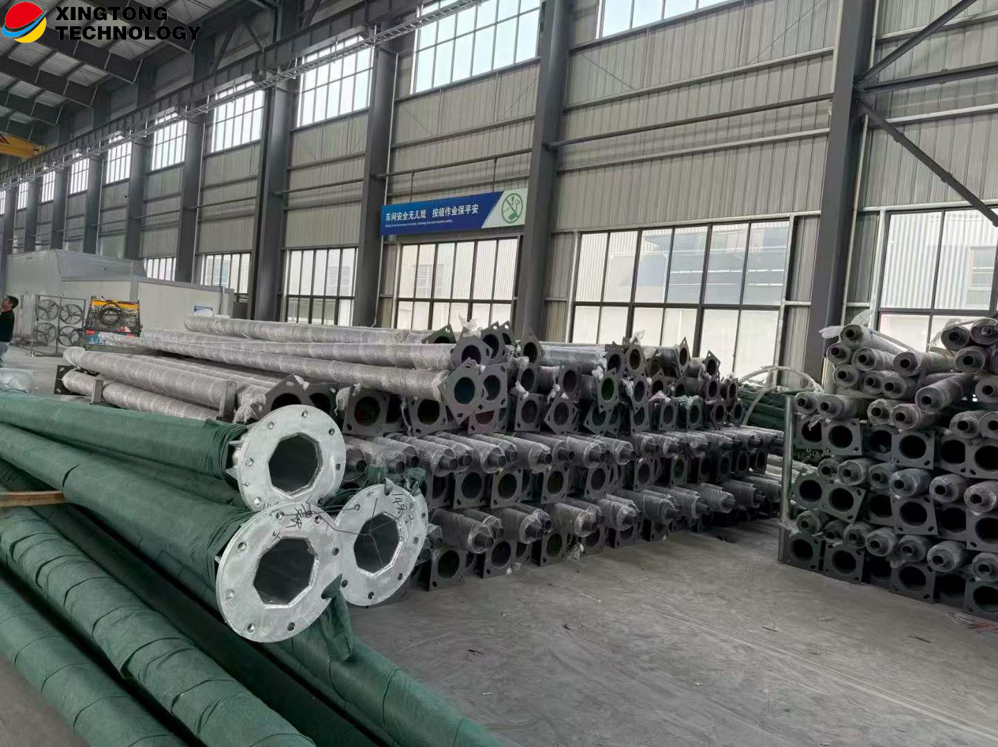 Lighting pole sections with flanged bases and protective wrapping
